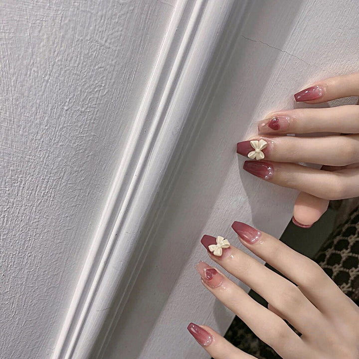 Artificial nails with heart accent and glamorous decorations Kalsten