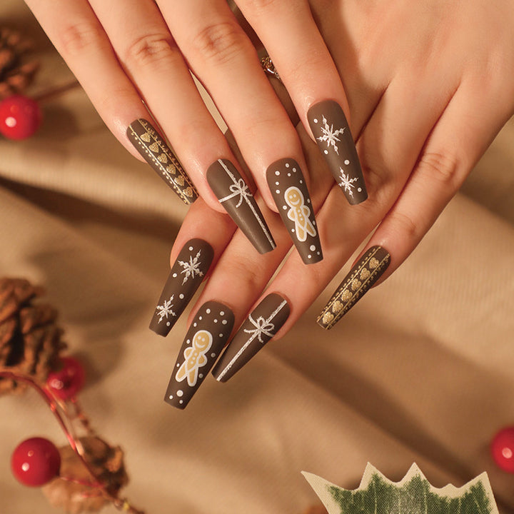 Artificial nail art with festive gingerbread design Kalsten