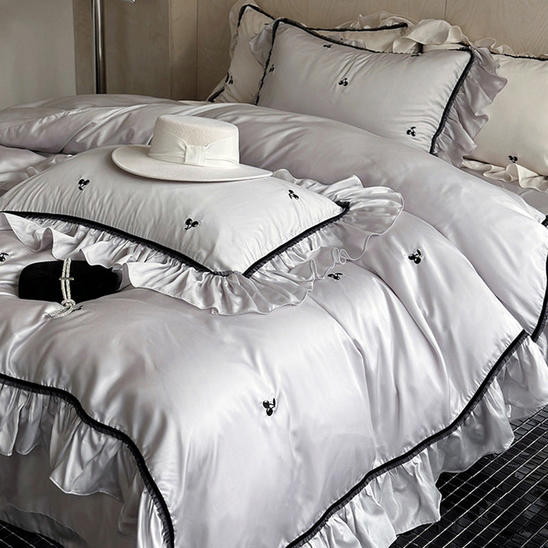 Silk-gloss satin bedding set with ruffled trim and delicate cherry embroidery