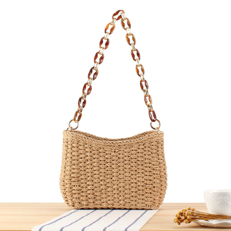 Stylish handbag made of woven natural material with exclusive chain accents Kalsten
