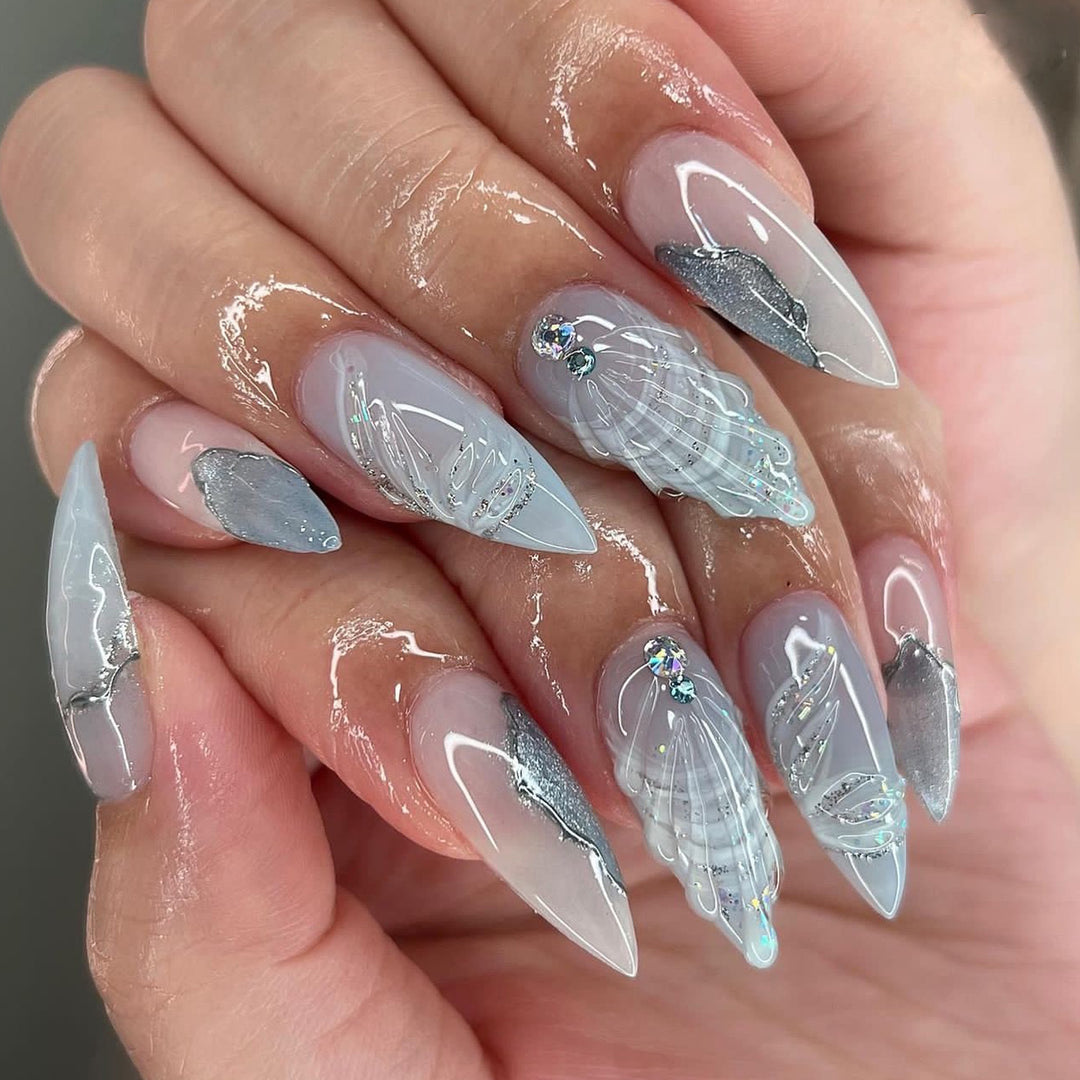 Artful stiletto nails with elegant glitter and floral design Kalsten