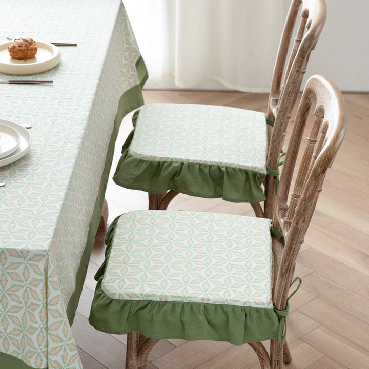 Padded chair cushion with ties, ruffled edge and embroidered hole pattern look Kalsten