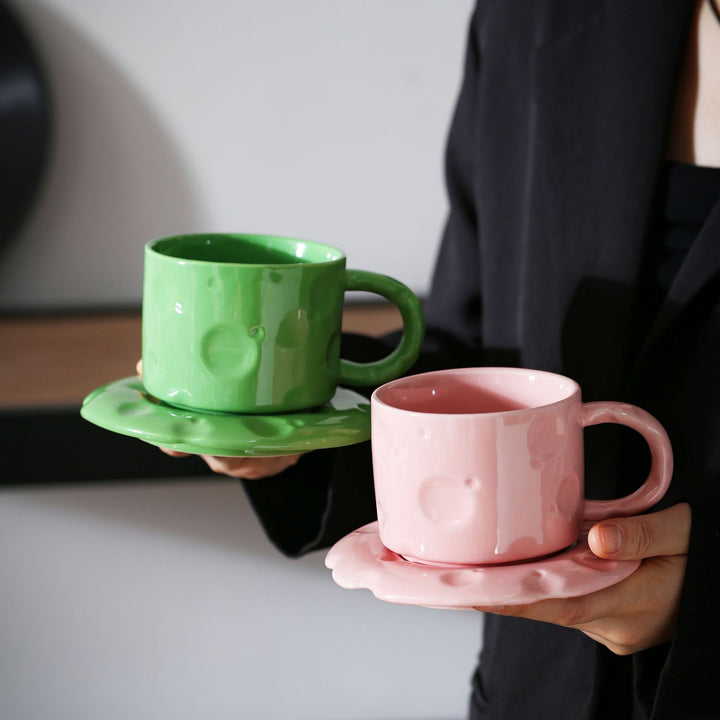 Ceramic coffee cup set with textured relief surface and wavy saucer