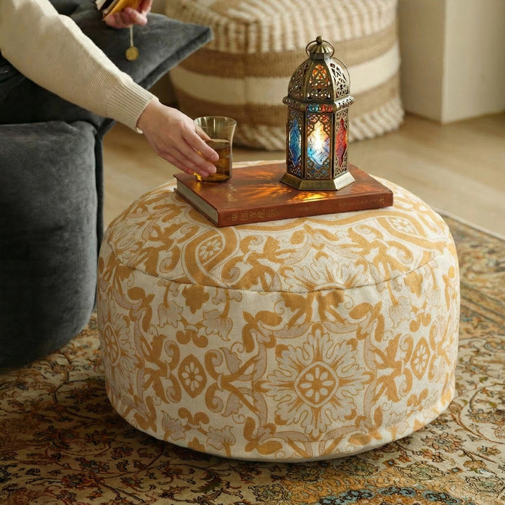 Round floor pouf with woven ornament pattern and carrying handle Kalsten