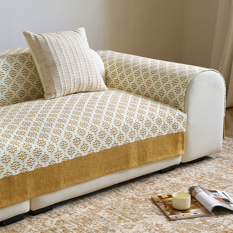 Knitted sofa cover with jacquard pattern and reinforced hem border Kalsten