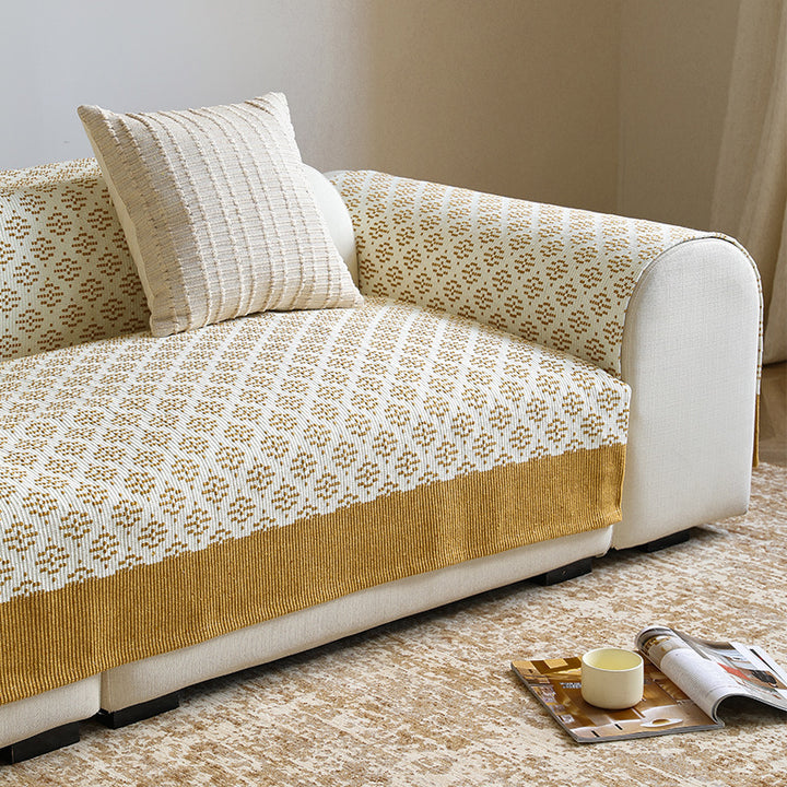 Knitted sofa cover with jacquard pattern and reinforced hem border Kalsten