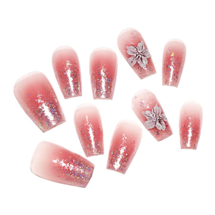 Artificial nail extensions with floral design and glitter accents Kalsten