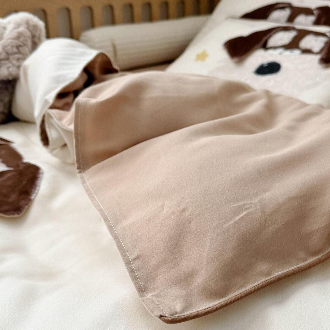Children's bedding set with detailed dog appliqué, velvet trim, and soft muslin