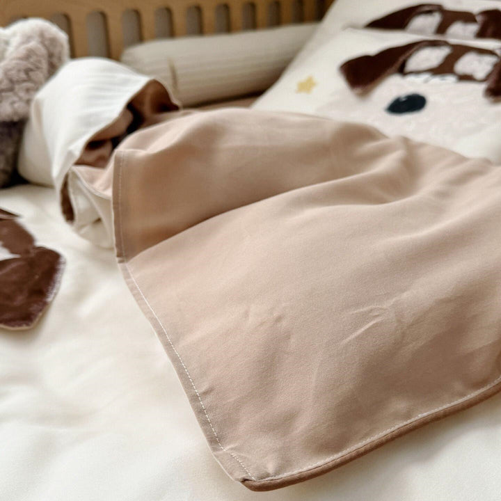 Children's bedding set with detailed dog appliqué, velvet trim, and soft muslin