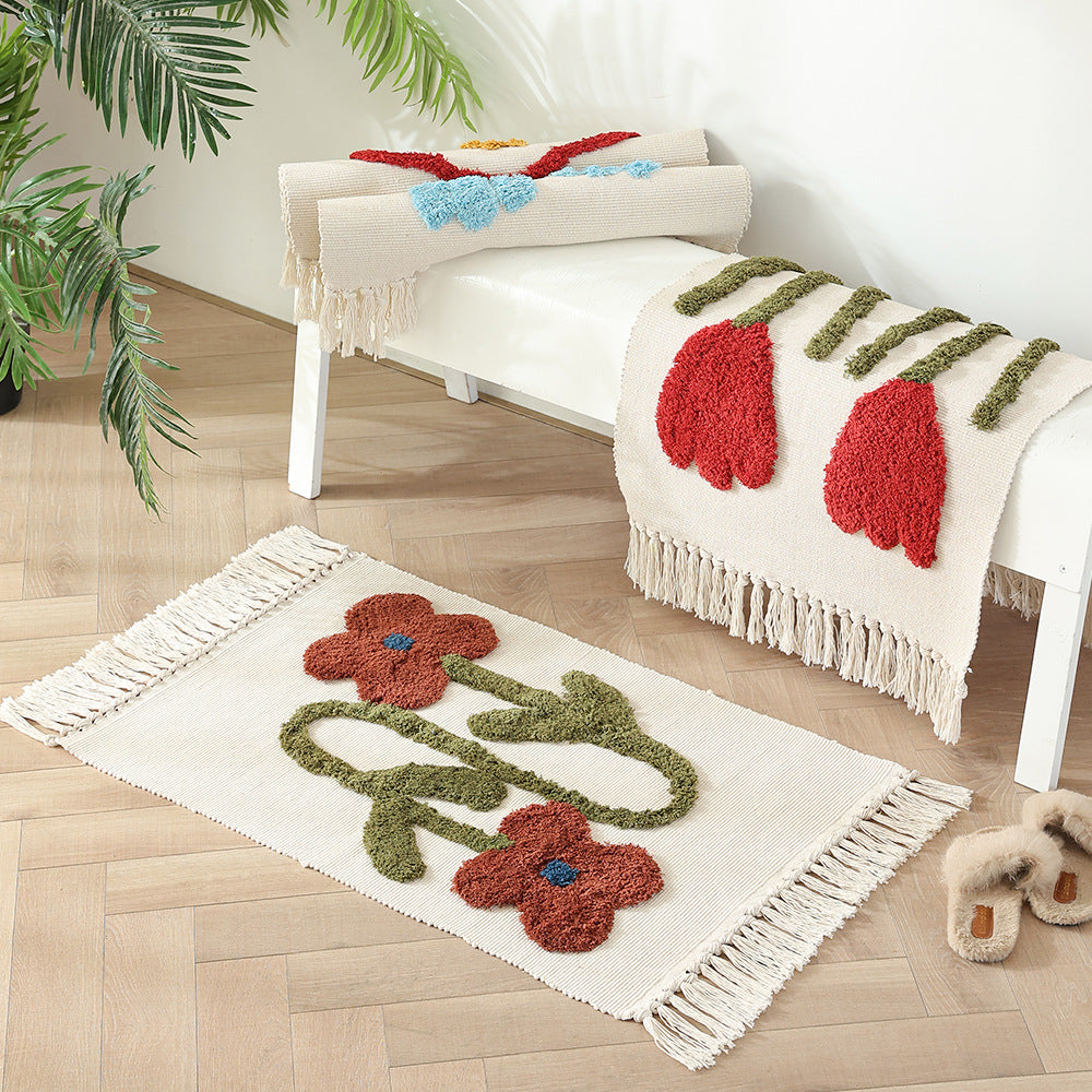 Handwoven cotton bath mat rug with tufted flower appliqué and tassels Kalsten