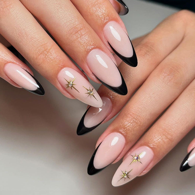 Artificial nail set with elegant black-and-white design and golden star accents Kalsten