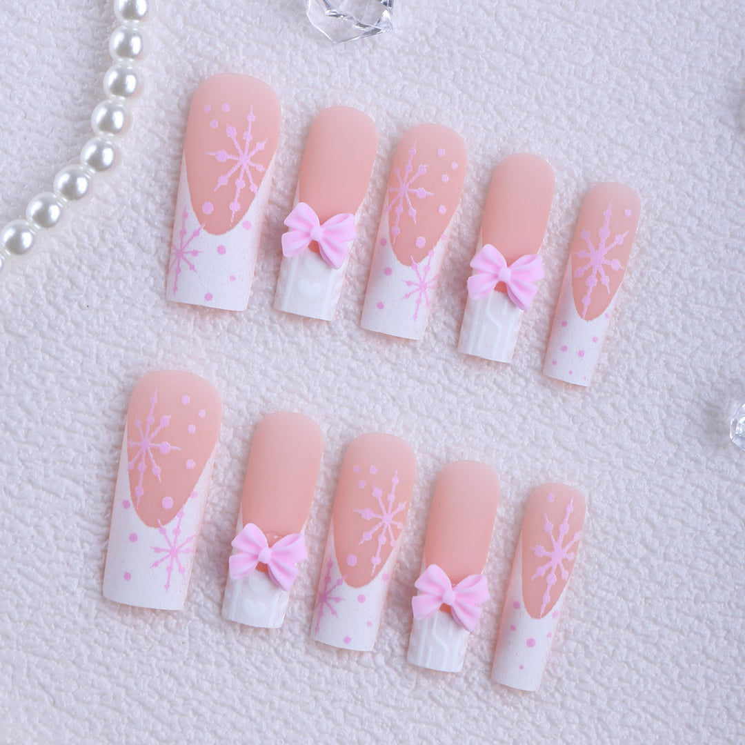 Artificial nail tips with playful bows and snowflake design Kalsten