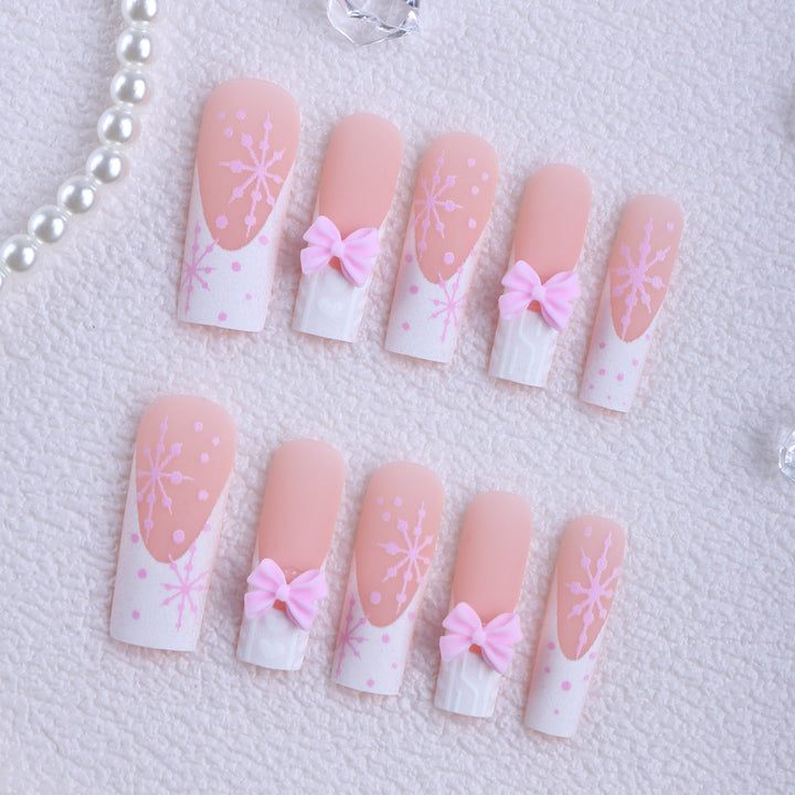Artificial nail tips with playful bows and snowflake design Kalsten