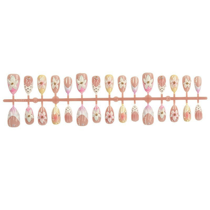 Artificial nail set with delicate floral designs and elegant accents Kalsten