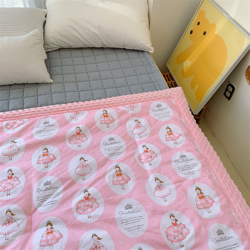 Children's quilt with colorful dinosaur print and soft minky border