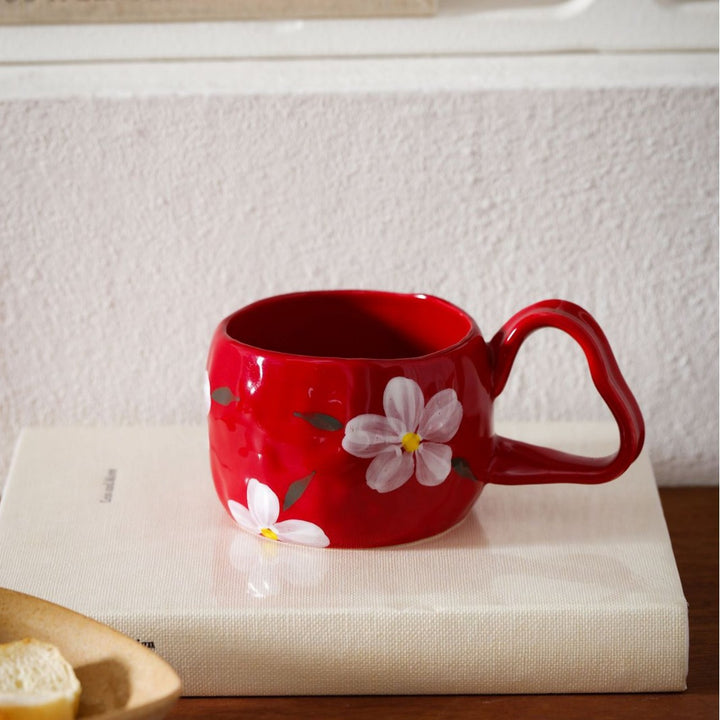 Ceramic mug with hand-painted stripes and flower design