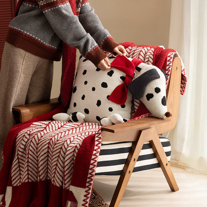 Decorative knitted cuddle pillow in the shape of a dog with a quilted body and bow detail Kalsten