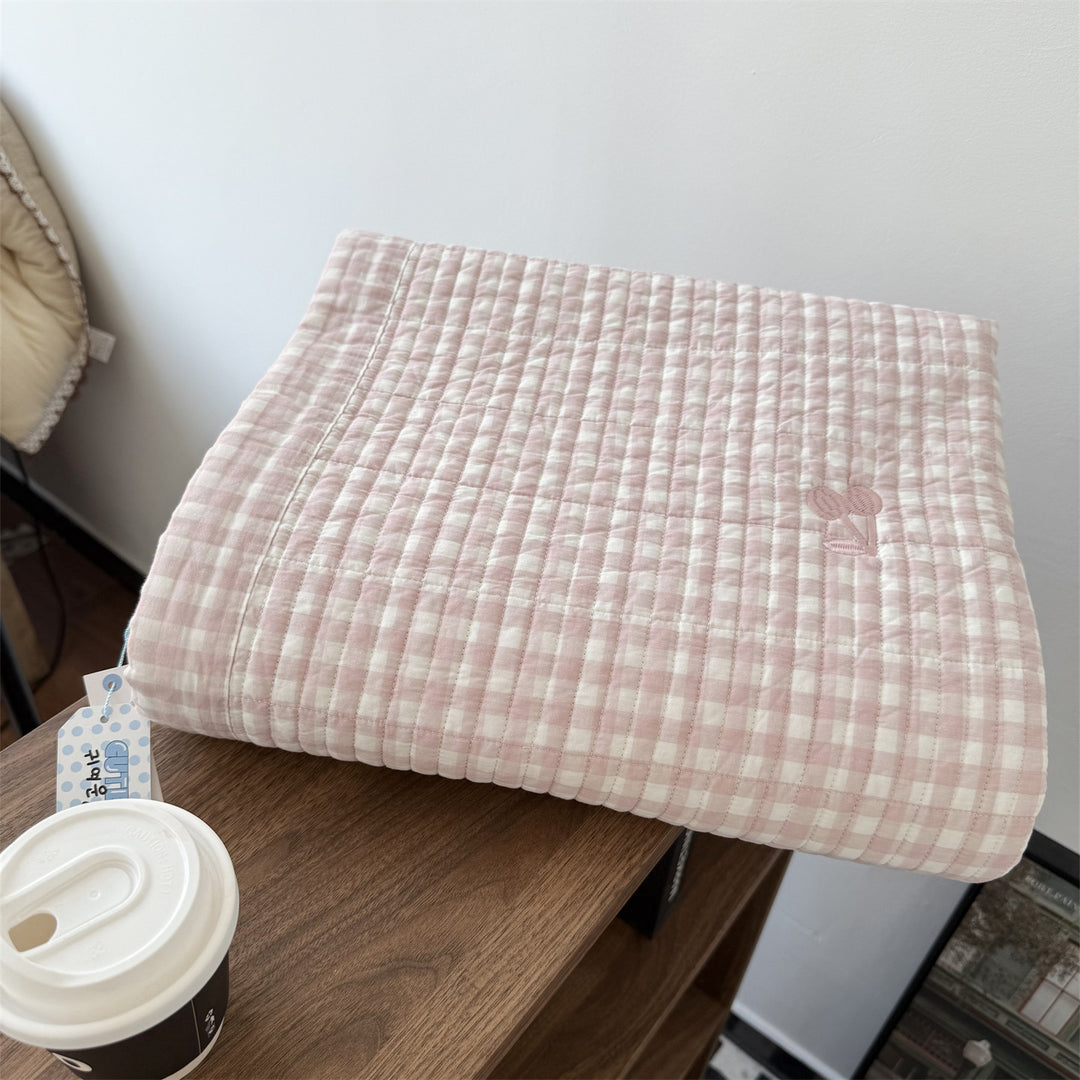 Quilted cotton bedspread with fine striped texture and cherry embroidery