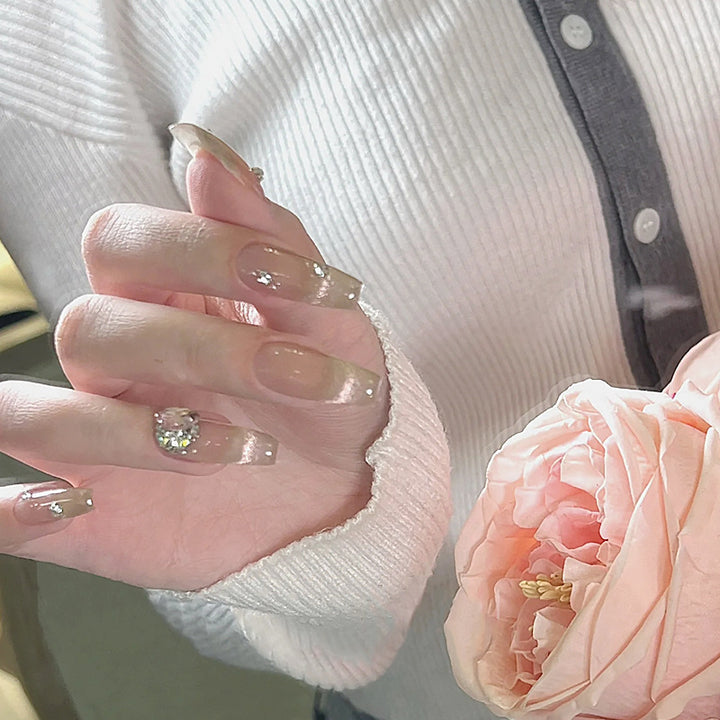 Acrylic nail set with glamorous glitter accents and elegant jewelry embellishments Kalsten