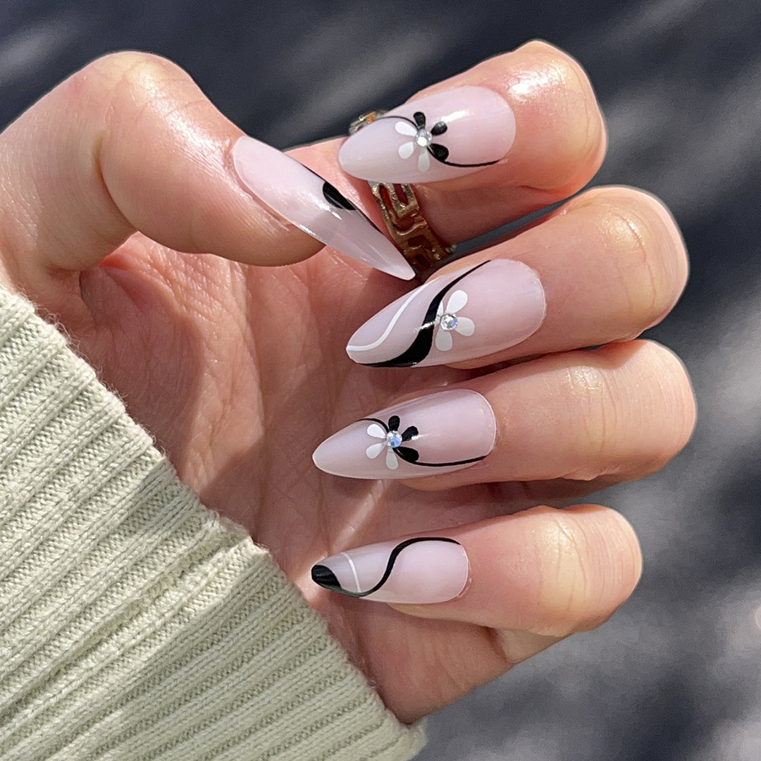 Artistic nail extensions with floral accents and glitter accents Kalsten