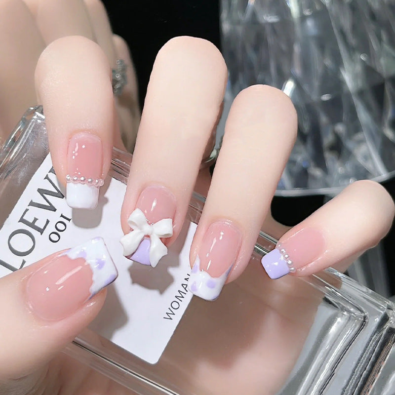 Nail art set with elegant wave patterns and delicate pearl accents Kalsten