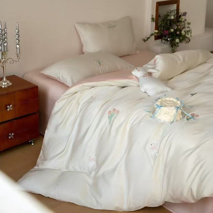 Luxurious satin bedding set with embroidered cherry motifs, reversible function and plush bunny pillow