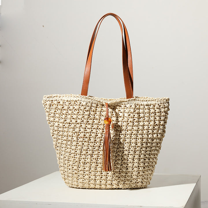 Handcrafted basket bag with fashionable tassel detail Kalsten