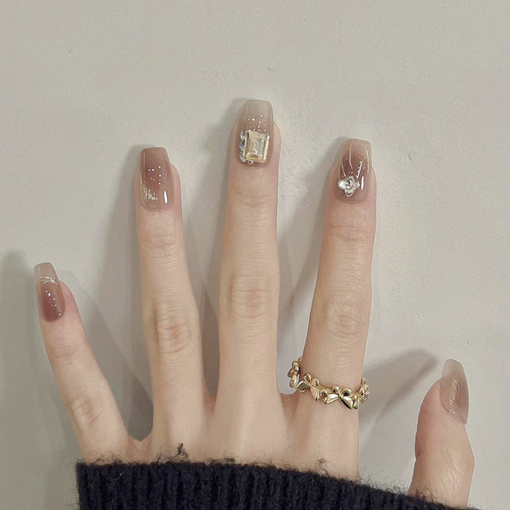 Artificial nail art with elegant jewelry accents Kalsten