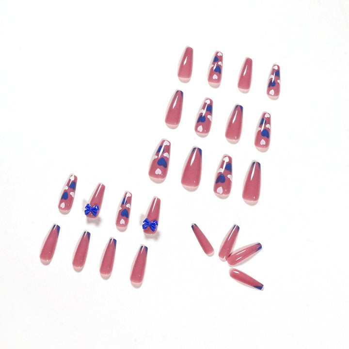 Artful stiletto nails with modern heart and bow motifs Kalsten