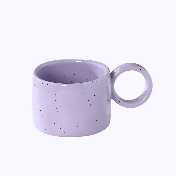 Ceramic mug with heart-shaped handle and speckle design