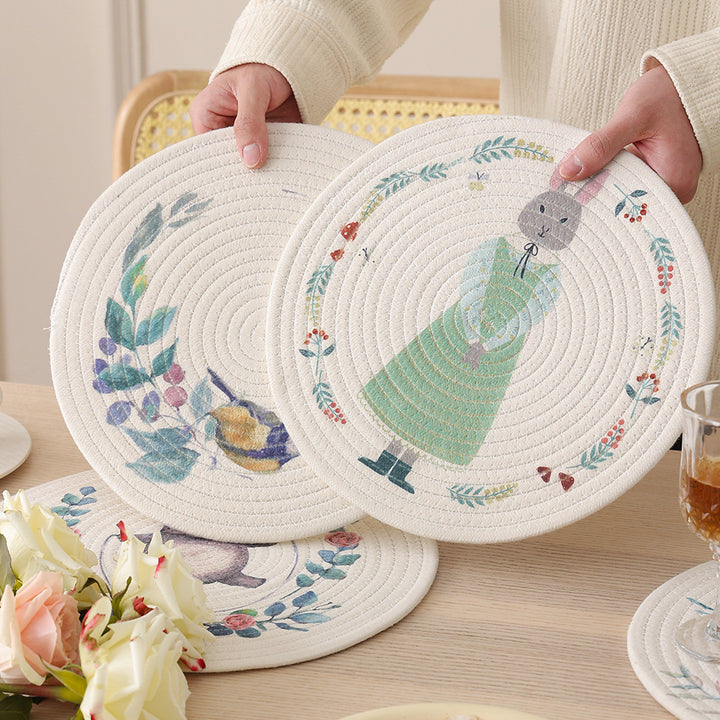 Round placemat made of woven cotton with a cute rhinoceros illustration and floral wreath Kalsten