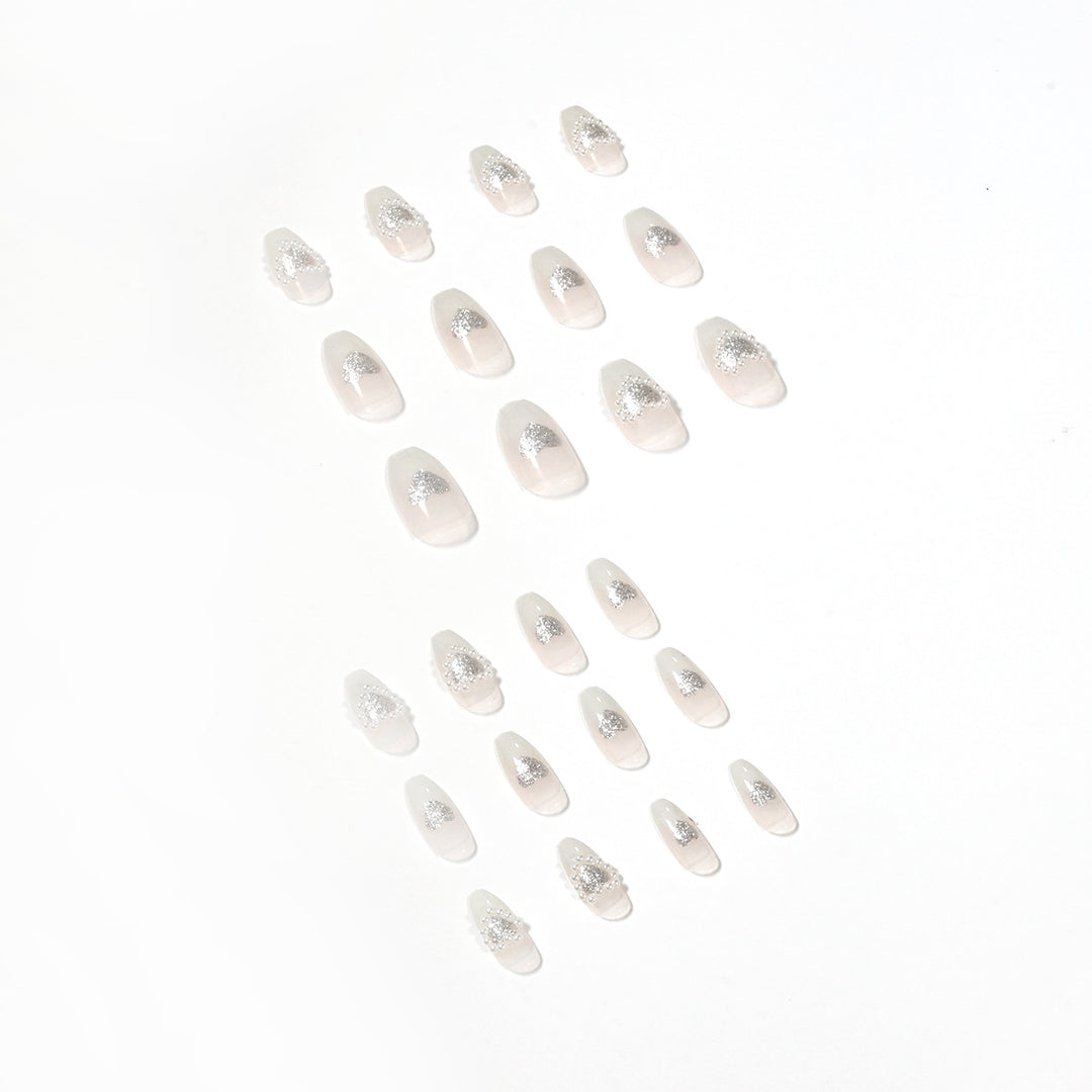 Artificial nail art with heart and rhinestone decorations Kalsten