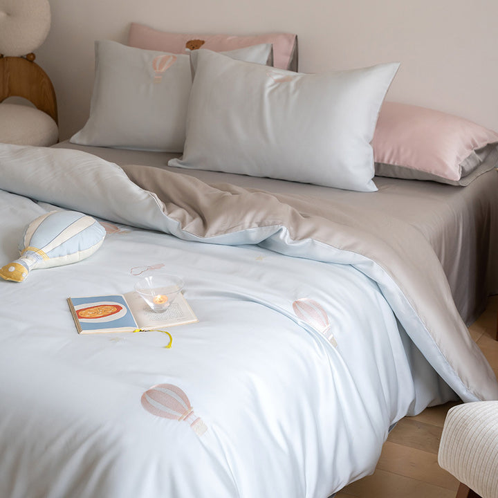 Luxurious satin bedding set with embroidered cherry motifs, reversible function and plush bunny pillow