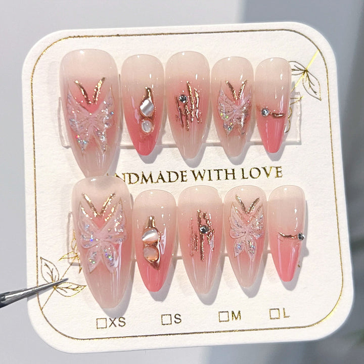 Artificial nail extensions with floral motifs and glitter accents Kalsten