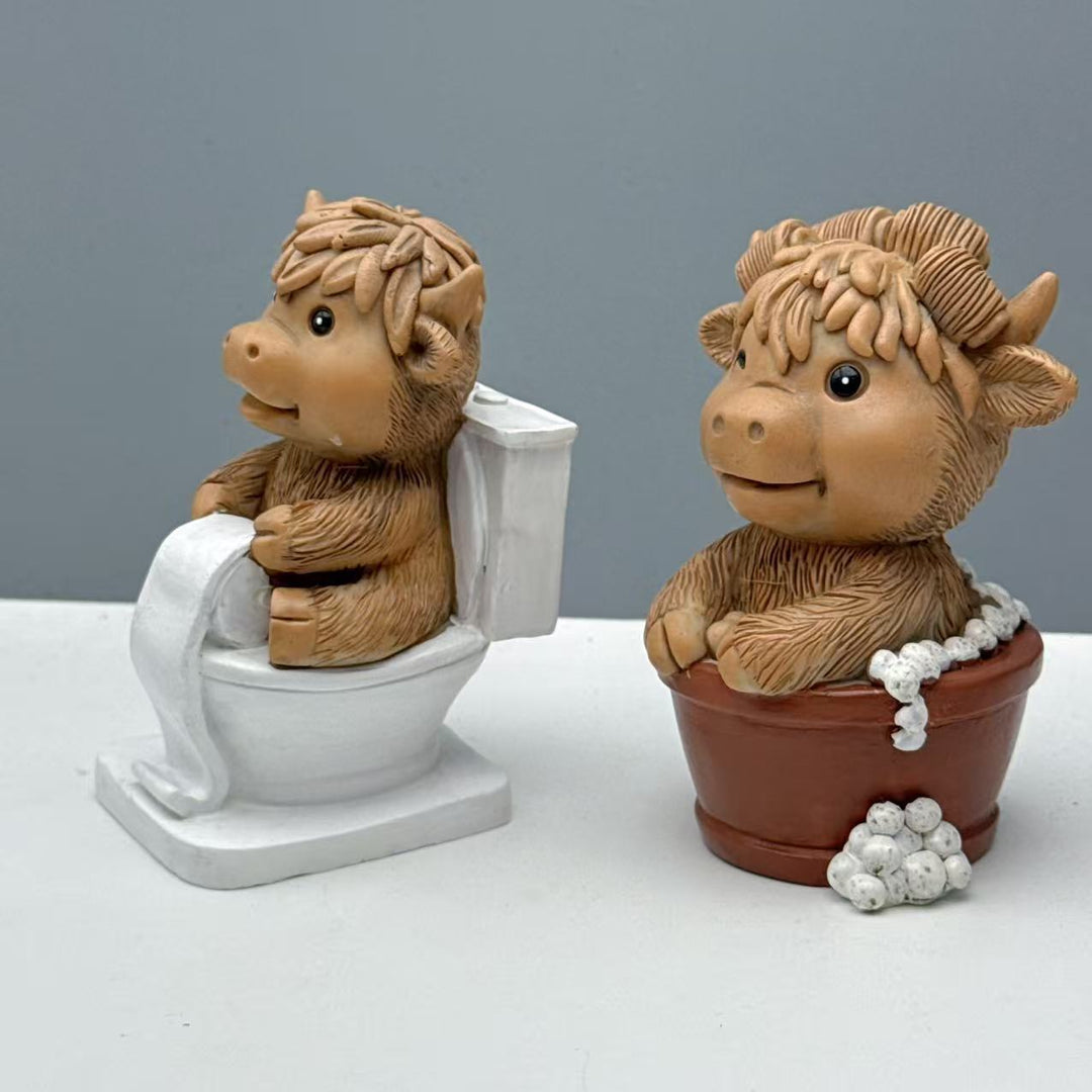 Funny decorative figure of a Highland cow on toilet Kalsten
