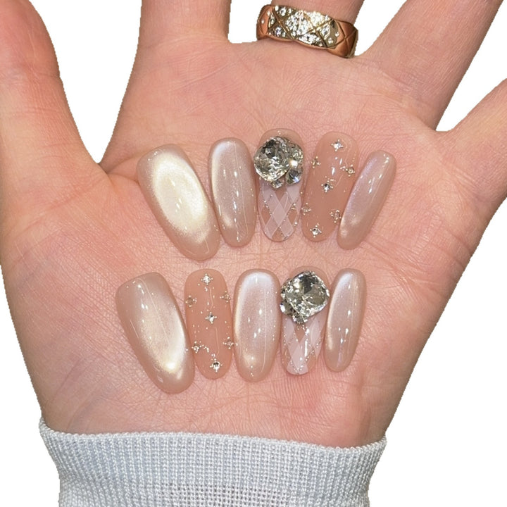 Elegant artificial nails with shimmering effects and rhinestone accents Kalsten