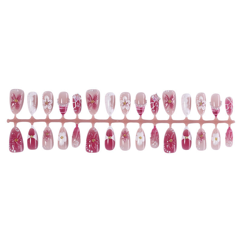 Creative acrylic nail set with floral accents and glitter decorations Kalsten