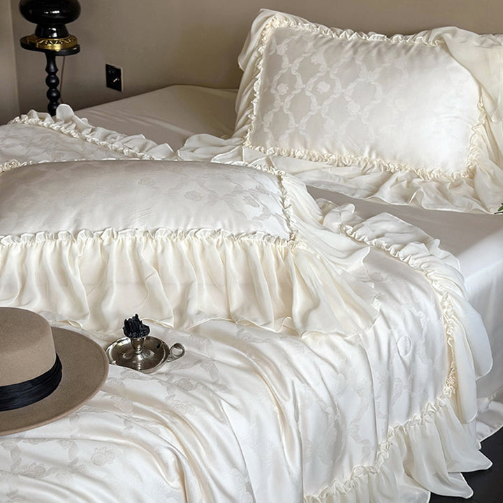 Elegant satin bed linen set with generous ruffle trim and tone-on-tone jacquard pattern