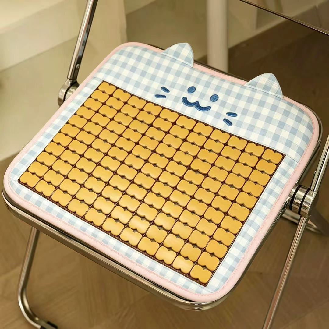 Padded seat cushion with massage stones and cat appliqué