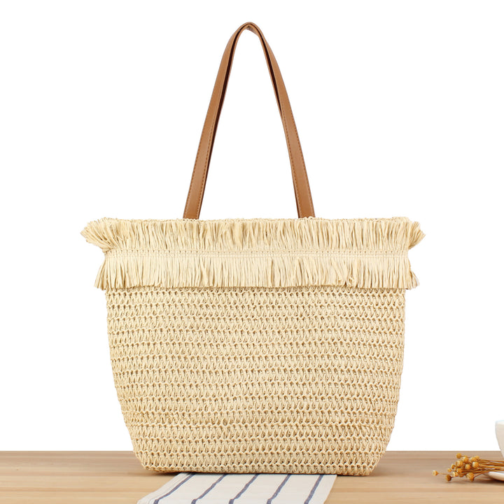 Beach bag made of handwoven natural material with fringe decoration Kalsten