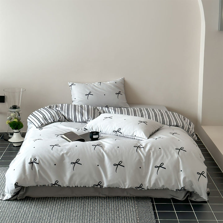 Modern cotton bedding set with minimal bow print and striped reversible side