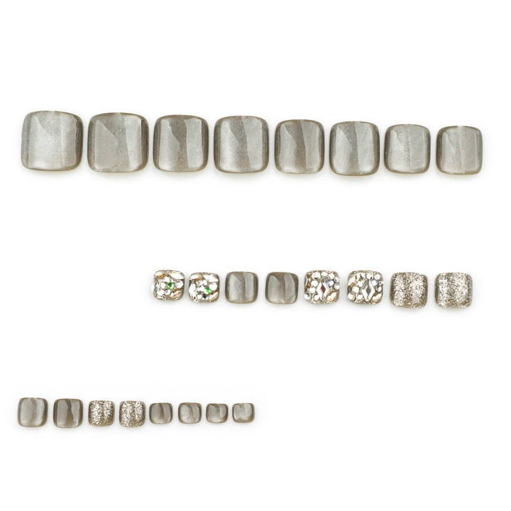 Artful toenail design with glitter and rhinestone decorations Kalsten