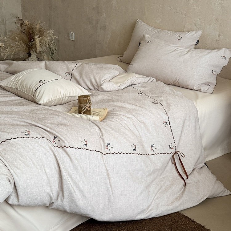 Embroidered bed linen set made of cotton-linen with delicate floral embroidery, wavy edge and ties.