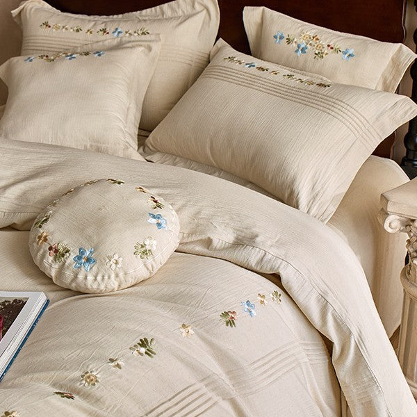 Soft cotton gauze bed set with hand-stitched flowers and decorative ruffle