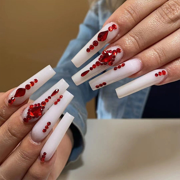 Artful nail extensions with glitter accents and elegant embellishments Kalsten