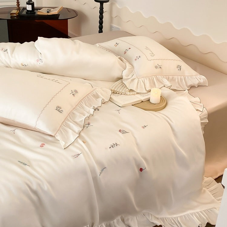 Romantic cotton satin bedding set with delicate floral embroidery and ruffle trim