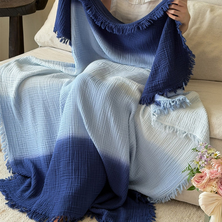 Large waffle blanket with ombre coloring and decorative fringes