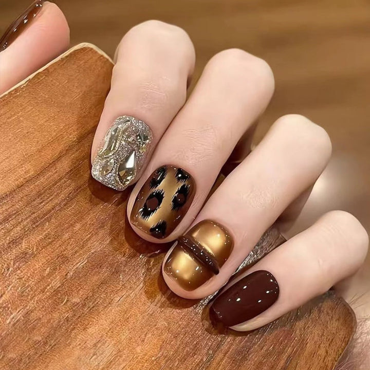 Glamorous artificial nails with animal design and glitter accents Kalsten