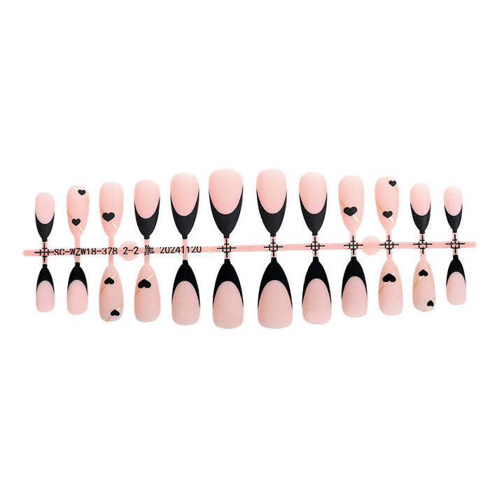 Creative nail art set with heart-shaped accents and elegant French tips Kalsten