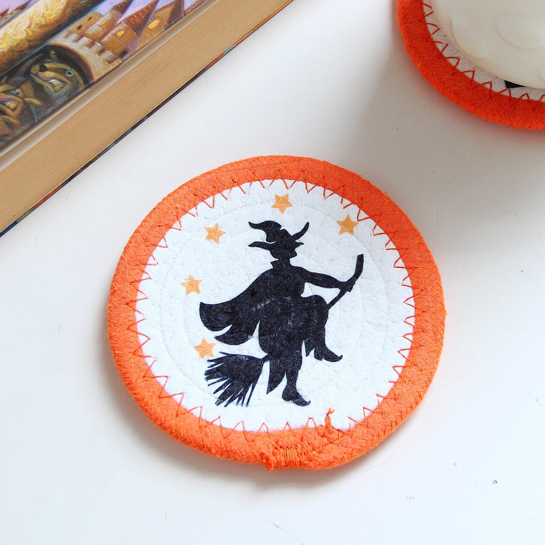 Round felt and cotton coasters with embroidered Halloween haunted house motif
